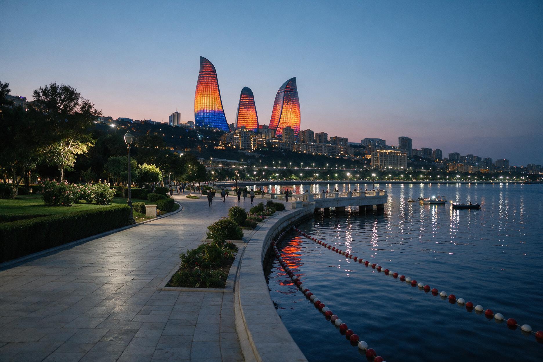 Baku Boulevard waterfront promenade along the Caspian Sea with Flame Towers illuminated at dusk