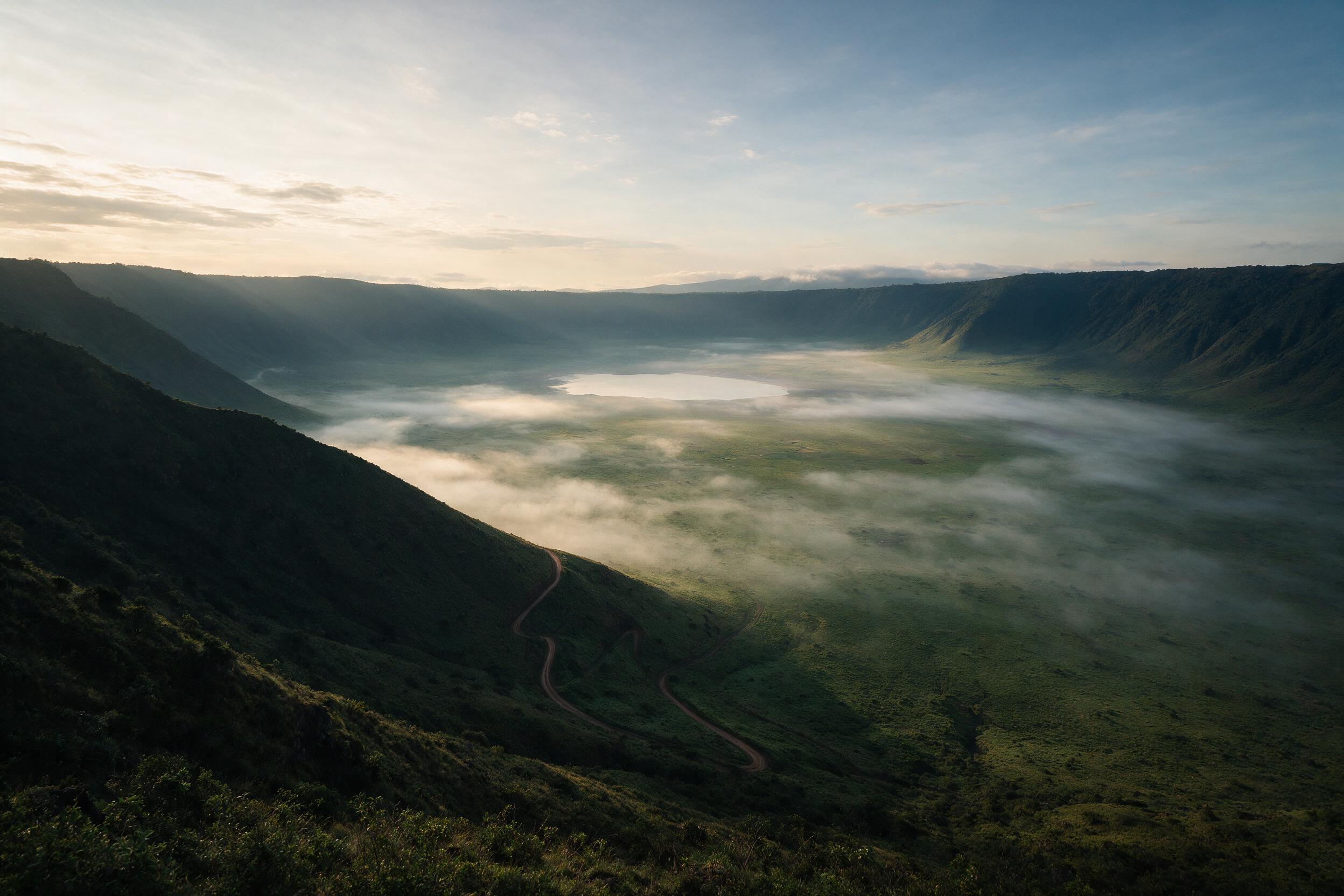Sunrise view into Ngorongoro Crater showing the full caldera floor and mist, Tanzania safari