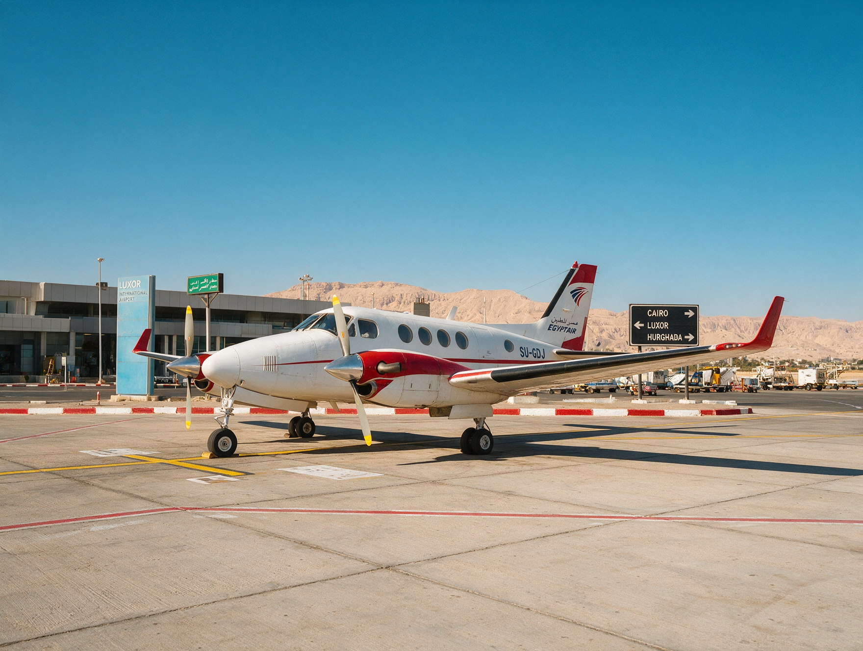 Domestic airplane at Luxor airport in Egypt with mountains in background